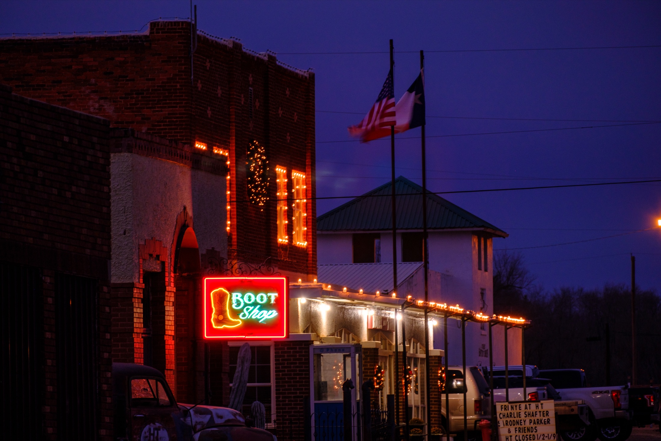 The Boot Shop building lit up at night